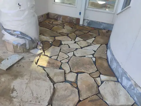 Flagstone being laid on a side entry