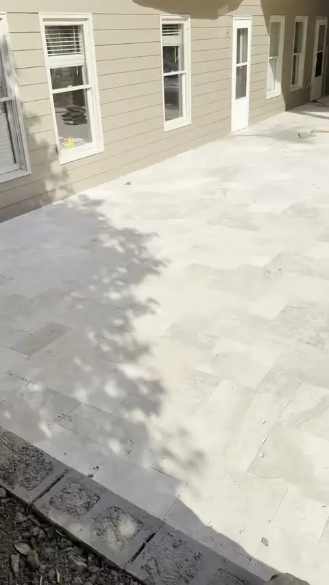 Large-format paver patio along the back of a house