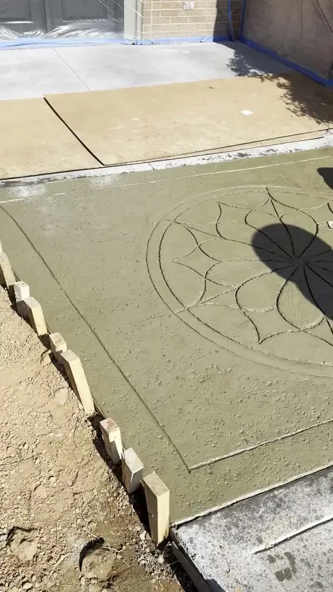 Stamped concrete with a medallion being finished