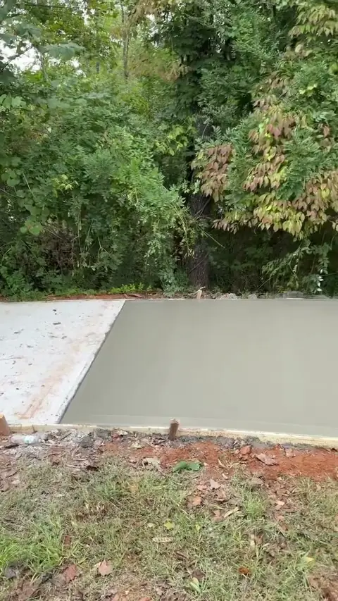 Concrete driveway pour with the crew finishing