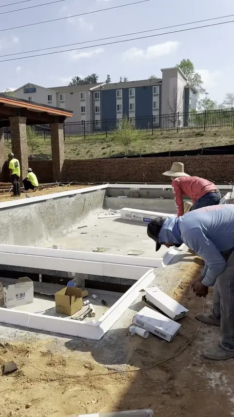 Forming a pool deck beside a covered pavilion